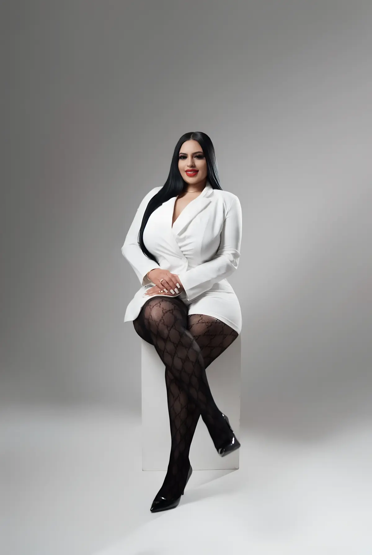 Daisy Luna, founder of Reliable Solutions Enterprise LLC, seated in a white blazer